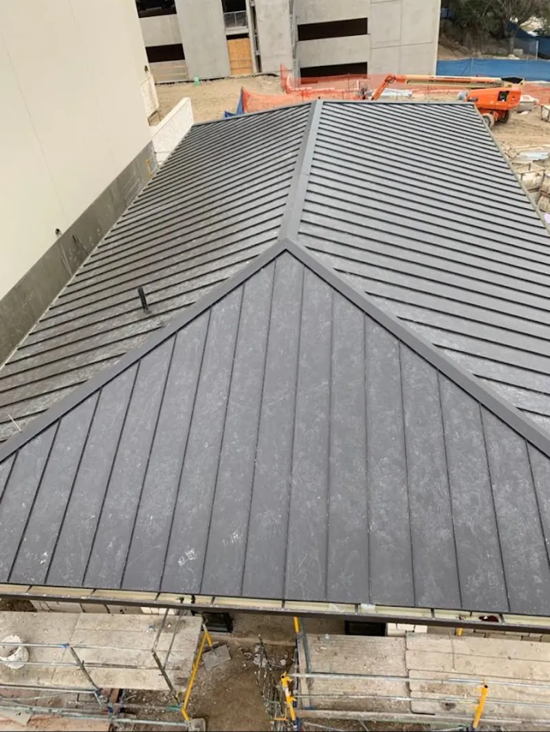 Commercial metal roof construction with crane equipment in Harrisburg